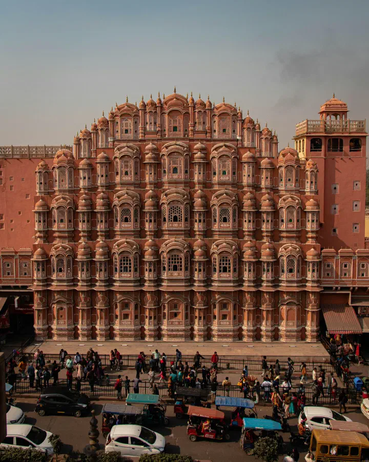 Front view of Hawa Mahal, a tall building with many windows, in Jaipur, India.